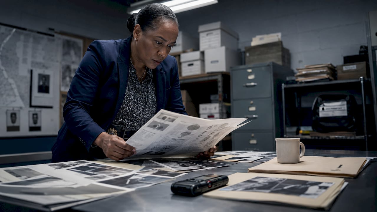 Detective reviewing forensic data dossier
