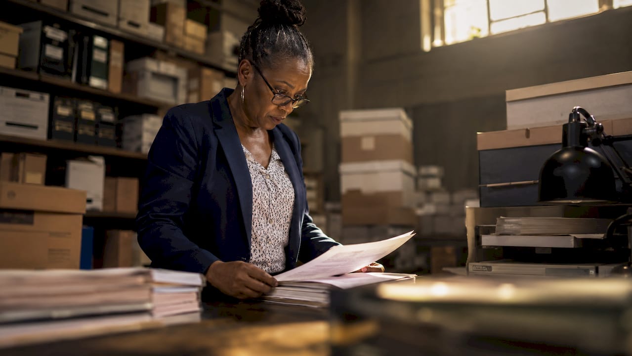 Investigator reviewing wrongful conviction case files
